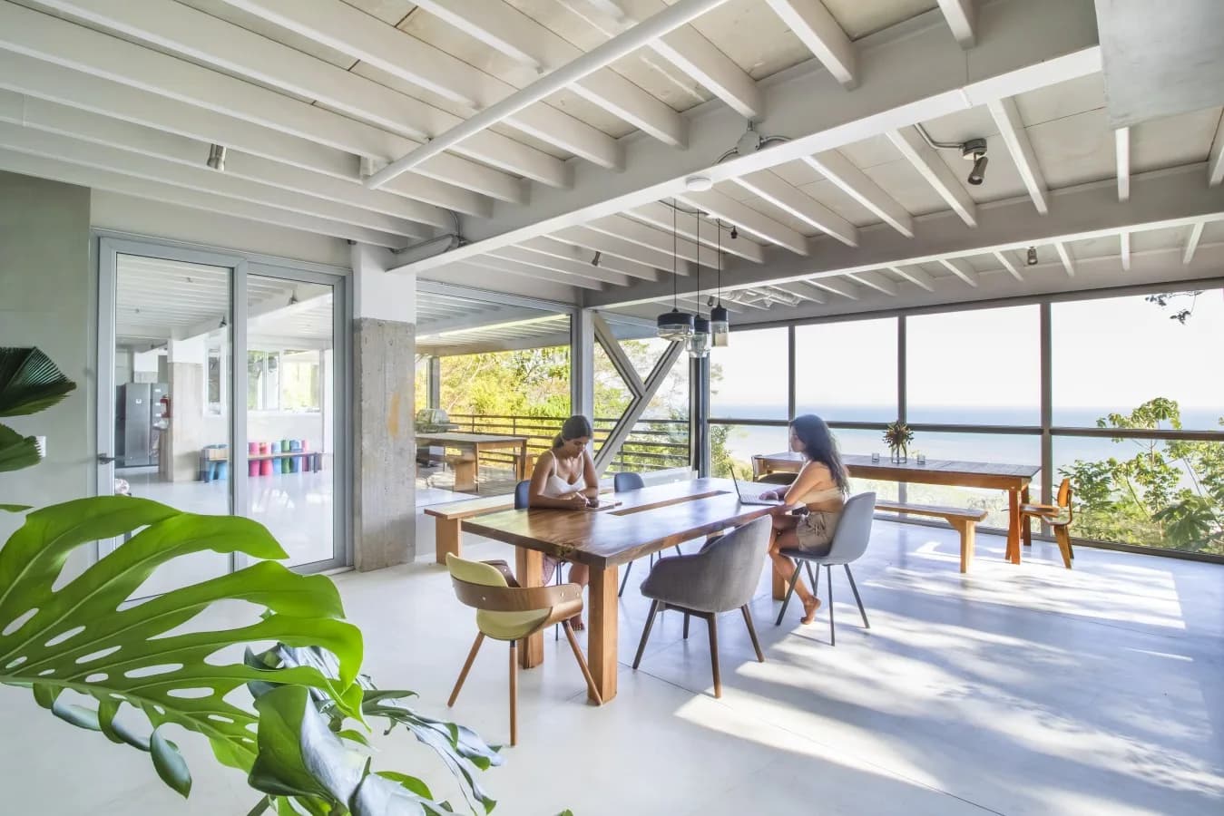 A sunny shared terrace overlooking the ocean, with space to sit and unwind