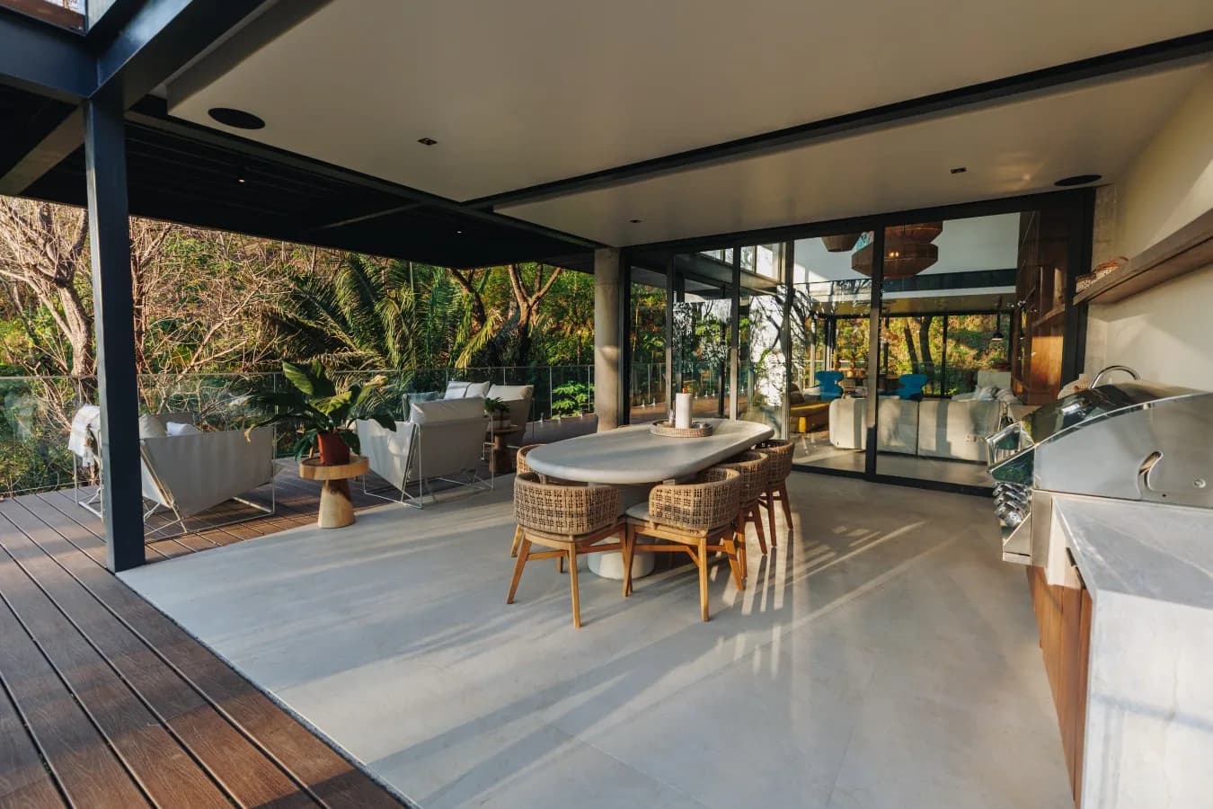 An open-air lounge surrounded by tropical greenery